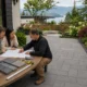 Contractor discussing paver patio costs with homeowners at a Lower Mainland BC property.