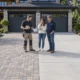 Side-by-side comparison of interlocking pavers and poured concrete driveways for a BC home.